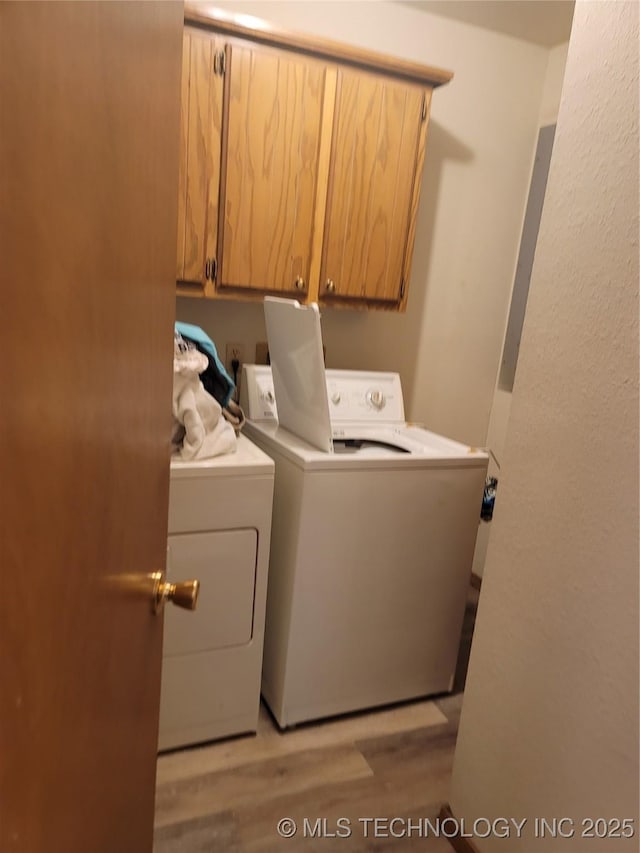 363 W 1700th Rd, Stigler, OK 74432 - washroom featuring cabinet space, independent washer and dryer, light wood-type flooring, and electric panel