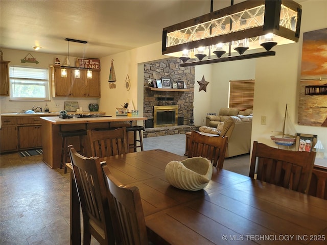 363 W 1700th Rd, Stigler, OK 74432 - dining room featuring a fireplace