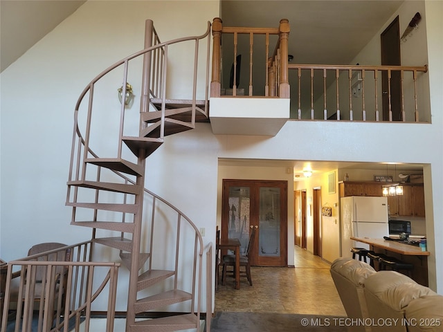 363 W 1700th Rd, Stigler, OK 74432 - staircase with a high ceiling and french doors