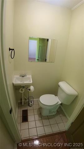 411 S 3rd, Eufaula, OK 74432 - half bath featuring toilet, tile patterned floors, and baseboards