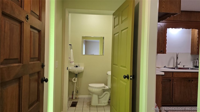 411 S 3rd, Eufaula, OK 74432 - bathroom with toilet, a sink, tile patterned flooring, and baseboards