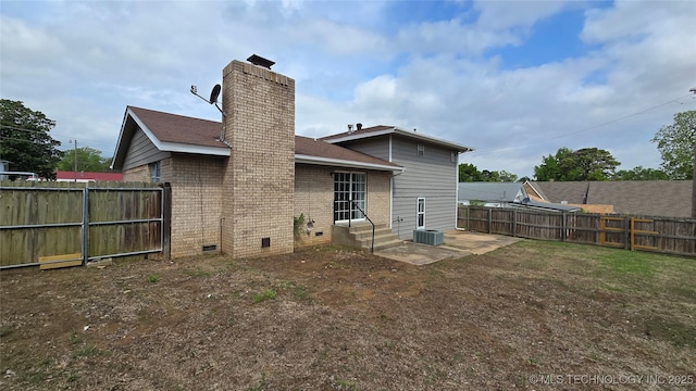 411 S 3rd, Eufaula, OK 74432 - back of property with a fenced backyard, a chimney, crawl space, brick siding, and entry steps