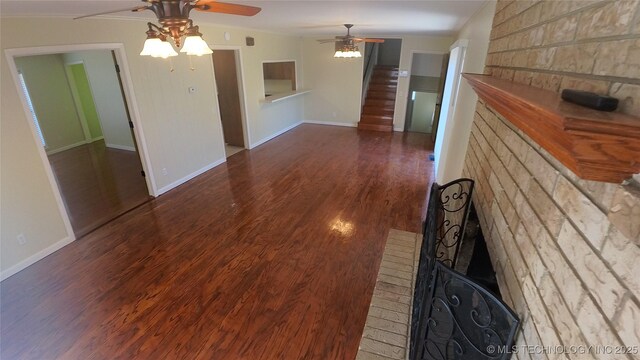 411 S 3rd, Eufaula, OK 74432 - unfurnished living room featuring ceiling fan, wood finished floors, stairs, baseboards, and ornamental molding
