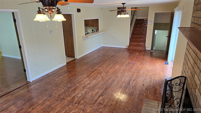 411 S 3rd, Eufaula, OK 74432 - unfurnished living room featuring a ceiling fan, stairs, wood finished floors, baseboards, and crown molding
