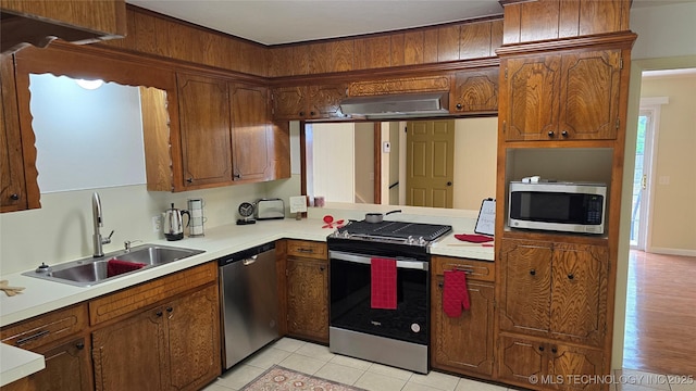 411 S 3rd, Eufaula, OK 74432 - kitchen with appliances with stainless steel finishes, a sink, light countertops, and brown cabinetry