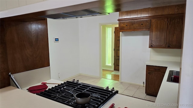 411 S 3rd, Eufaula, OK 74432 - kitchen with light countertops, light tile patterned floors, a sink, and baseboards