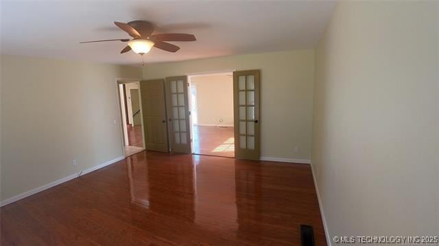 411 S 3rd, Eufaula, OK 74432 - empty room with ceiling fan, wood finished floors, and baseboards