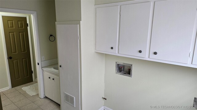 411 S 3rd, Eufaula, OK 74432 - laundry room featuring washer hookup, cabinet space, baseboards, and light tile patterned floors