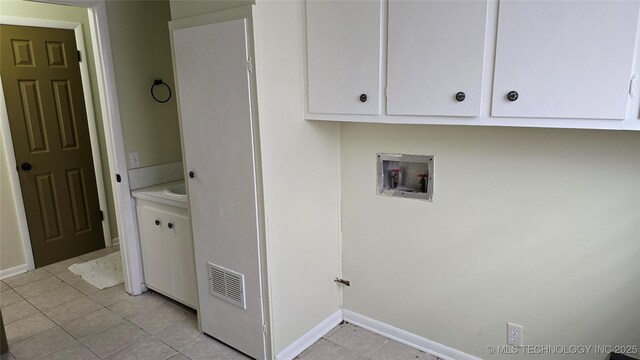 411 S 3rd, Eufaula, OK 74432 - washroom with washer hookup, light tile patterned flooring, baseboards, and cabinet space