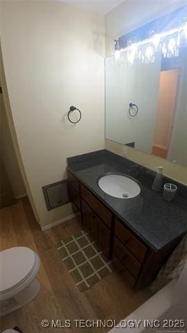 411 S 3rd, Eufaula, OK 74432 - bathroom featuring wood finished floors, vanity, and toilet