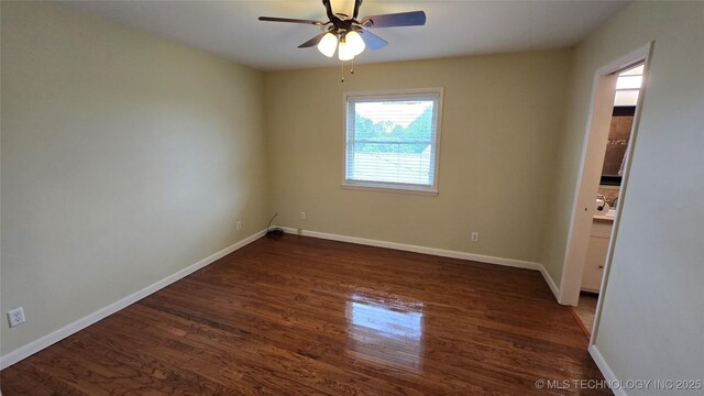 411 S 3rd, Eufaula, OK 74432 - empty room with dark wood-style floors, a ceiling fan, and baseboards