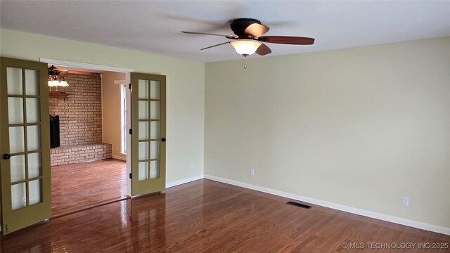 411 S 3rd, Eufaula, OK 74432 - unfurnished room featuring wood finished floors, ceiling fan, baseboards, and french doors