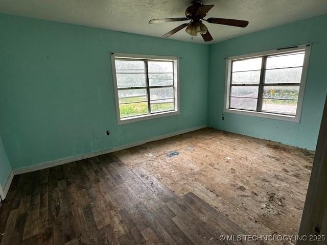 708 S 1st, Davis, OK 73030 - spare room with plenty of natural light, ceiling fan, baseboards, and wood finished floors