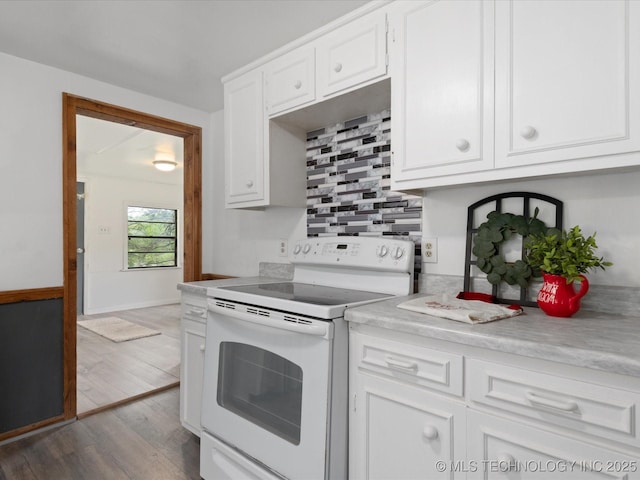 9 L B May Scenic Ln, Pawhuska, OK 74056 - kitchen with electric stove, wood finished floors, white cabinets, and light countertops