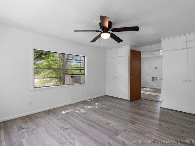 9 L B May Scenic Ln, Pawhuska, OK 74056 - unfurnished bedroom featuring two closets, baseboards, wood finished floors, cooling unit, and ornamental molding