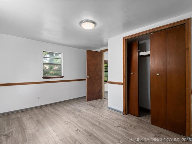 9 L B May Scenic Ln, Pawhuska, OK 74056 - unfurnished bedroom with light wood-style floors, a closet, and baseboards