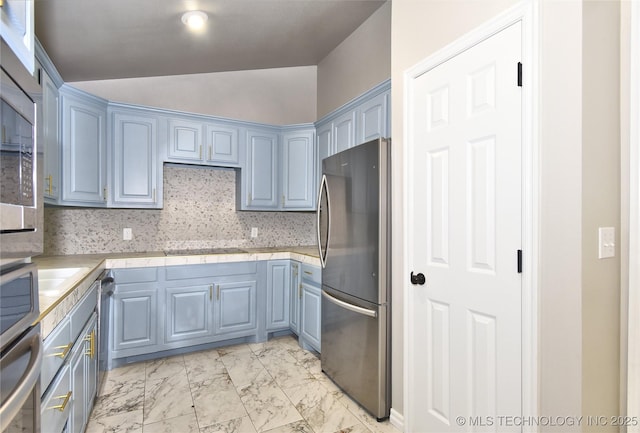 119 N 6th Mile, Fort Gibson, OK 74434 - kitchen featuring appliances with stainless steel finishes, vaulted ceiling, light marble finish flooring, light countertops, and blue cabinets