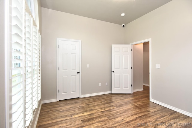 119 N 6th Mile, Fort Gibson, OK 74434 - unfurnished bedroom featuring dark wood-style flooring and baseboards