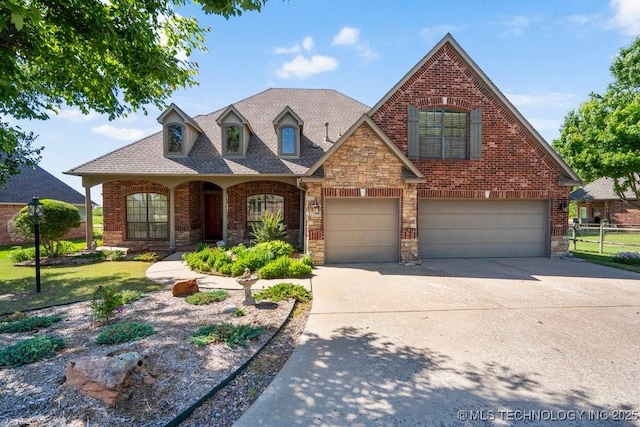 view of front of property featuring concrete driveway, brick siding, stone siding, fence, and a garage