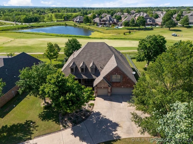 view from above of property with a nearby body of water and a local golf course