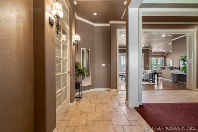 hall with ornamental molding, recessed lighting, stone tile flooring, and baseboards