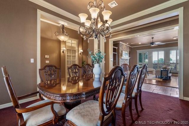 carpeted dining room with ornamental molding, a chandelier, baseboards, a ceiling fan, and tile patterned flooring