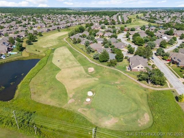 aerial overview of property's location featuring nearby suburban area, a nearby body of water, and a golf course