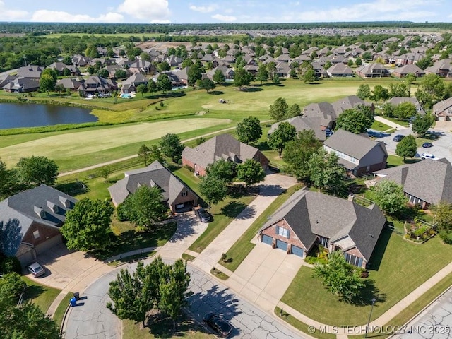 aerial perspective of suburban area with a golf course and a large body of water