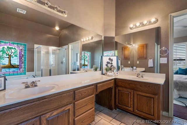 bathroom with a stall shower, double vanity, tile patterned flooring, and connected bathroom