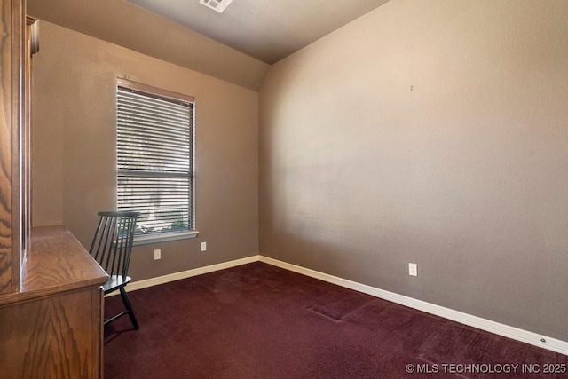 unfurnished office with dark colored carpet, baseboards, and lofted ceiling