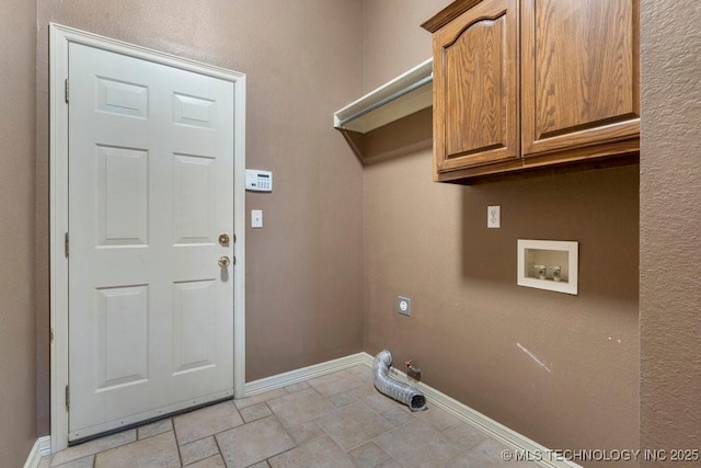 laundry room featuring hookup for a washing machine, cabinet space, baseboards, gas dryer hookup, and light stone finish flooring
