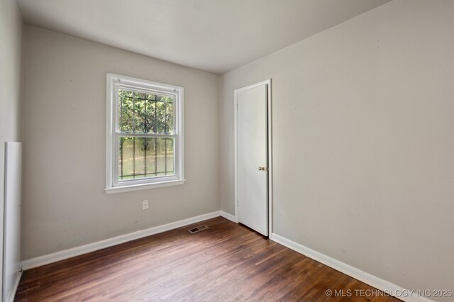 4272 E Young Pl, Tulsa, OK 74115 - unfurnished room with dark wood-style flooring and baseboards