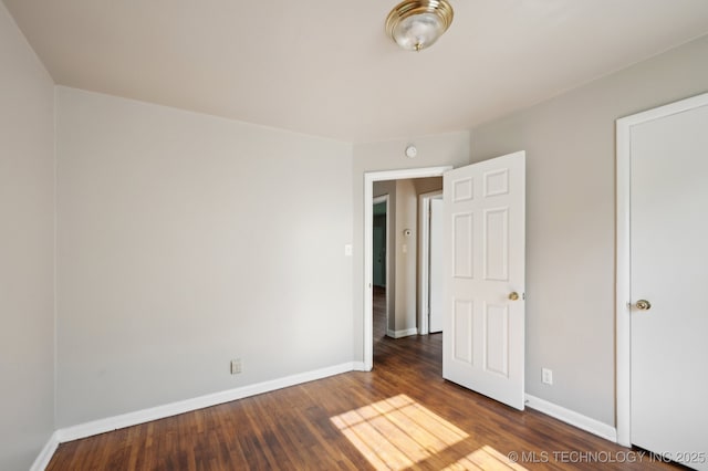 4272 E Young Pl, Tulsa, OK 74115 - unfurnished bedroom featuring wood finished floors and baseboards