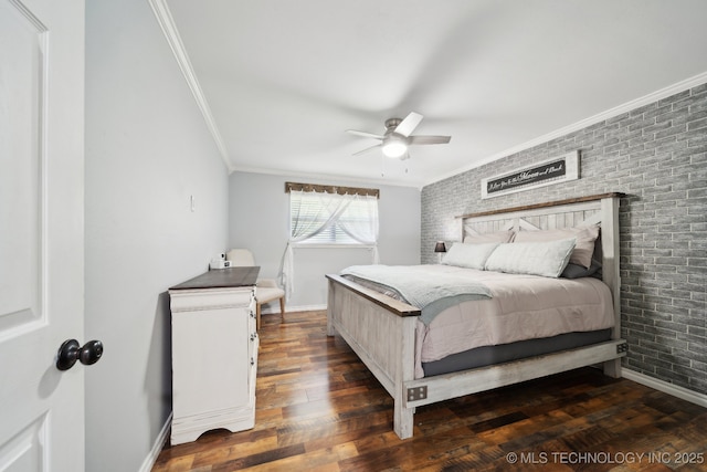 bedroom with crown molding, baseboards, brick wall, dark wood-type flooring, and a ceiling fan