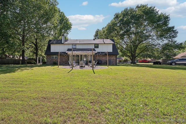 back of house with a pergola, a patio area, brick siding, and a fire pit