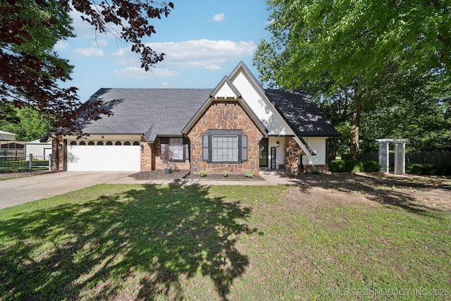 tudor-style house featuring stone siding, concrete driveway, a garage, and roof with shingles