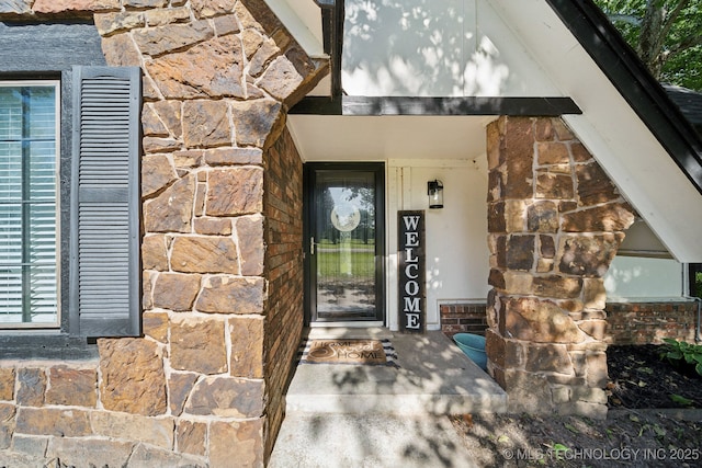 property entrance featuring stone siding