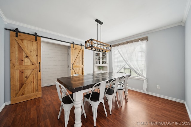 dining room featuring a barn door, crown molding, baseboards, and dark wood-style flooring