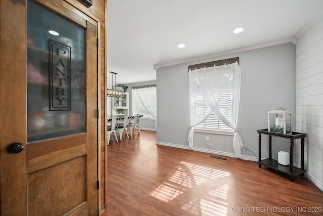 hallway featuring crown molding, wood finished floors, baseboards, and recessed lighting