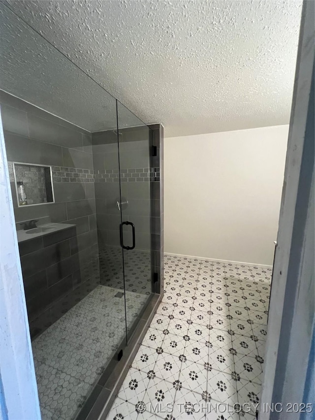 514 Lakeshore St, Durant, OK 74701 - full bathroom featuring a textured ceiling, a shower stall, tile patterned floors, and baseboards