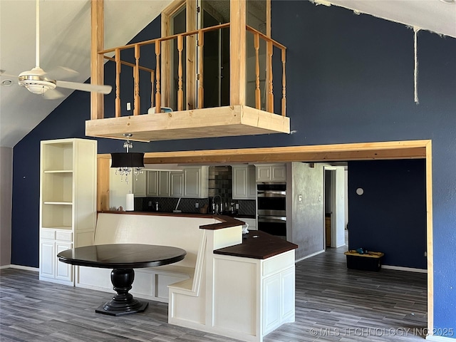514 Lakeshore St, Durant, OK 74701 - kitchen with stainless steel double oven, high vaulted ceiling, wood finished floors, a ceiling fan, and baseboards