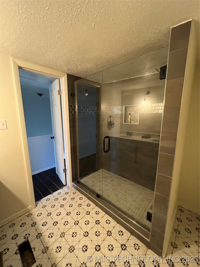 514 Lakeshore St, Durant, OK 74701 - full bath with a textured ceiling, a stall shower, and tile patterned floors
