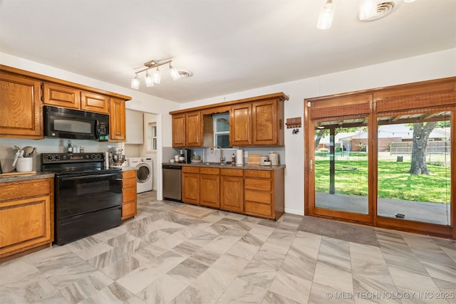 601 S White Ave, Wagoner, OK 74467 - kitchen featuring black appliances, washer / clothes dryer, brown cabinets, and a sink