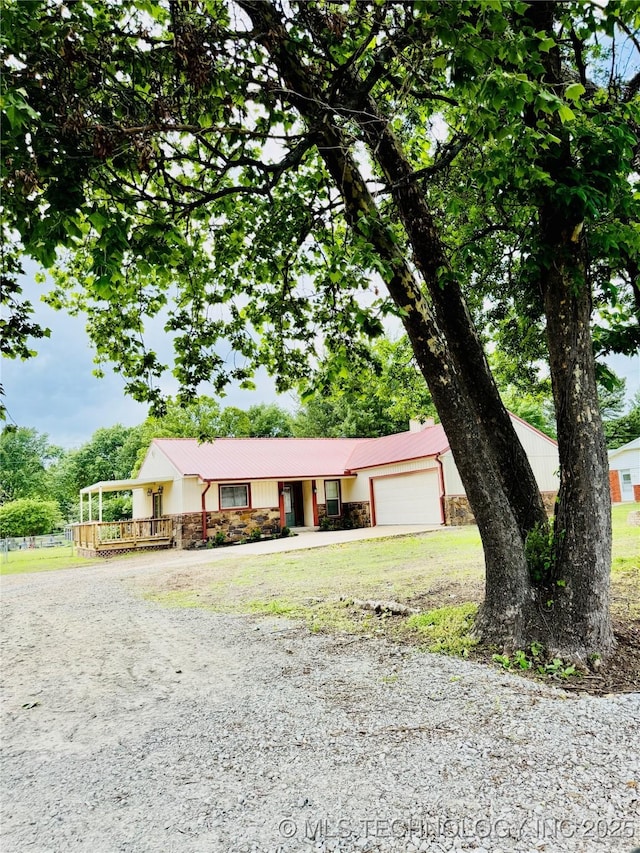 single story home featuring driveway, a garage, and a front yard