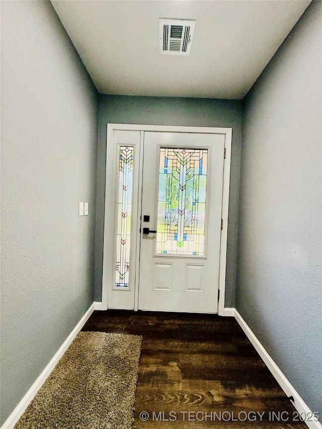 foyer with baseboards and dark wood-style floors