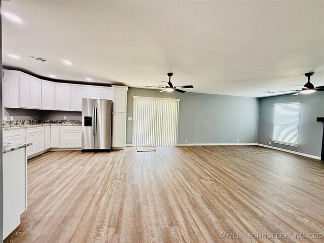 unfurnished living room featuring ceiling fan, light wood-type flooring, baseboards, and recessed lighting