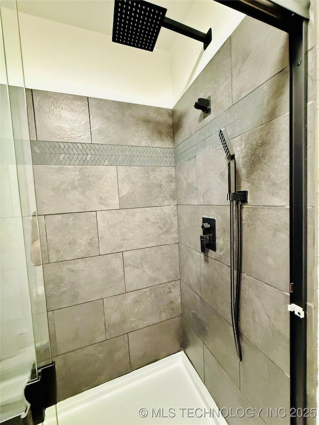 bathroom with a tile shower