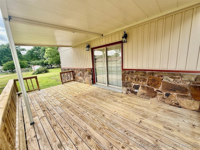 wooden deck featuring a yard