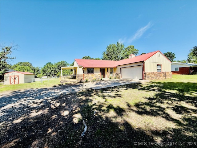 ranch-style home with stone siding, a chimney, a shed, a garage, and driveway