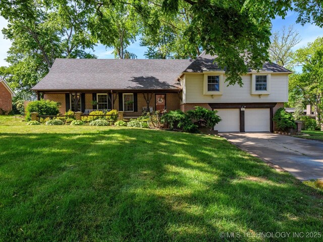 1811 Wayland Ct, Bartlesville, OK 74006 - tri-level home featuring brick siding, an attached garage, concrete driveway, and a front yard